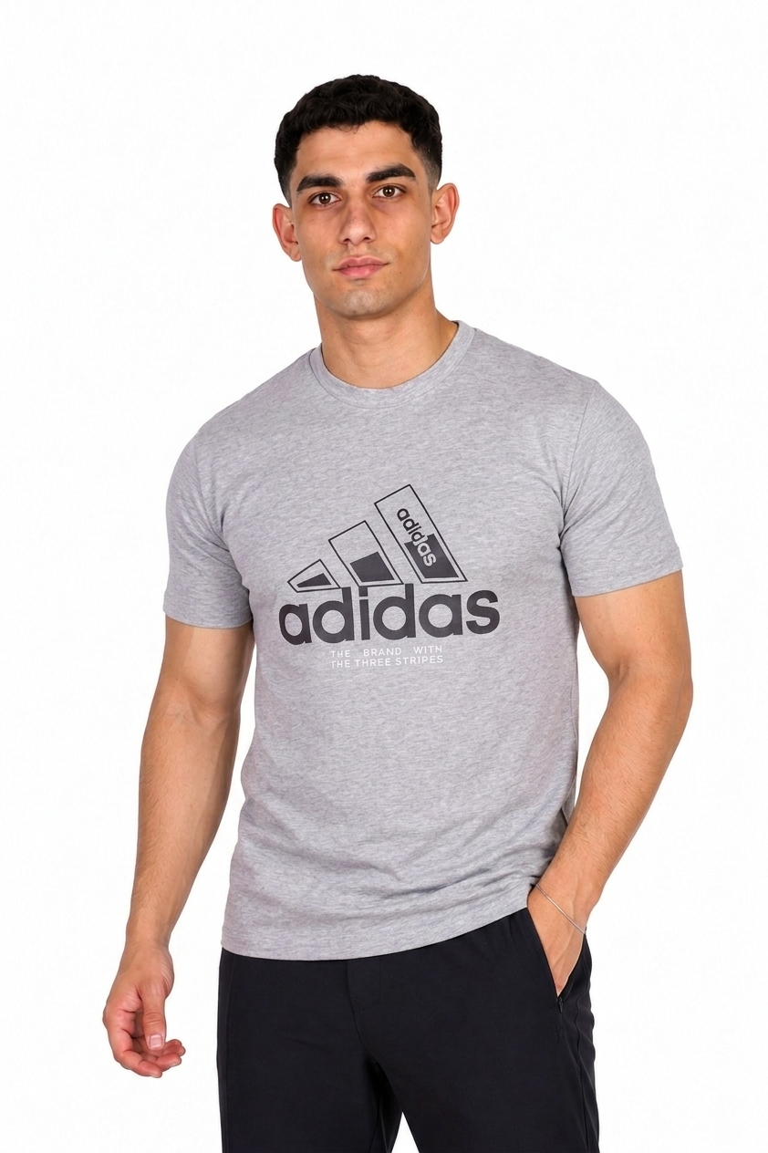 A man wearing a gray Adidas t-shirt