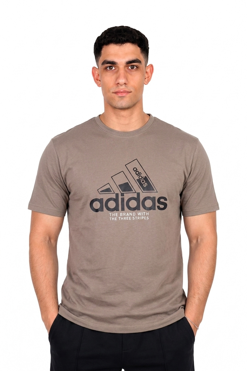 A man wearing a Taupe Adidas t-shirt