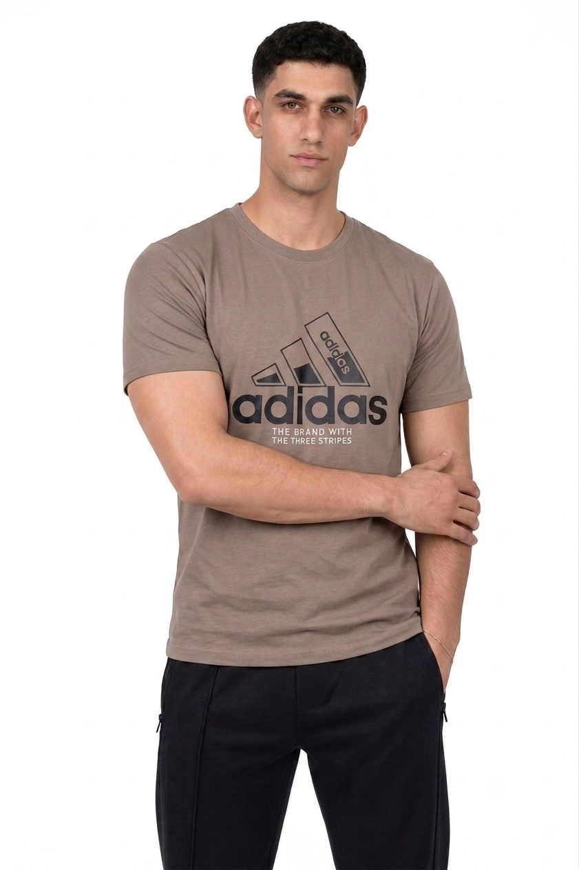 A man wearing a Taupe Adidas t-shirt