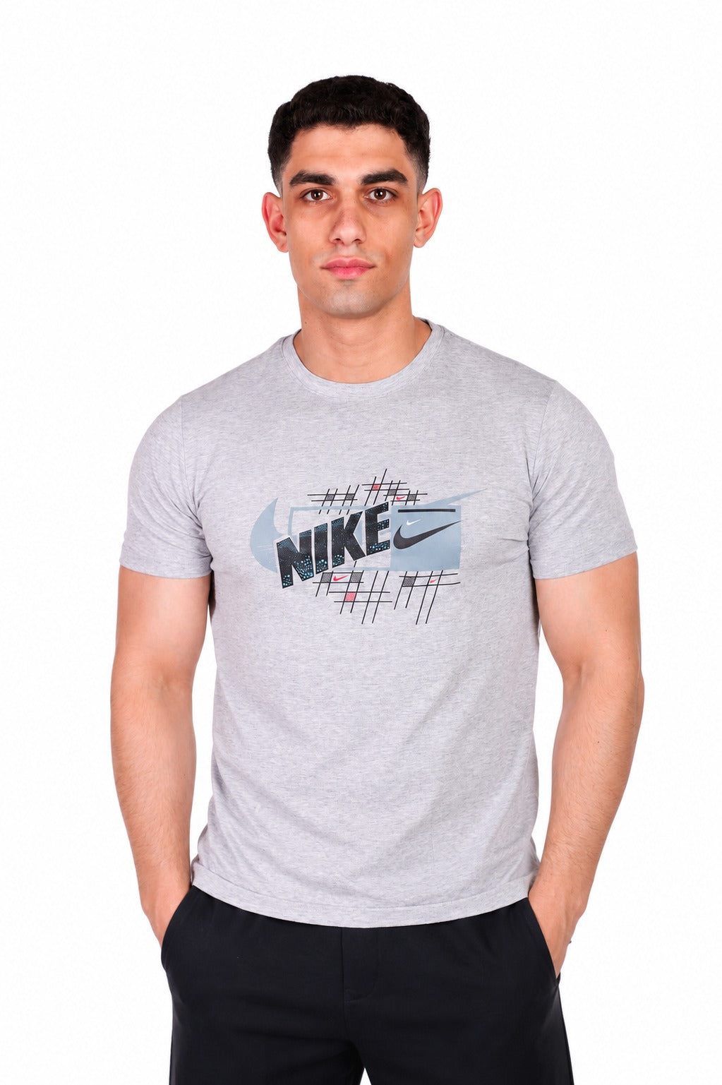 A man wearing a light gray heathered Nike t-shirt with a graphic print on the chest