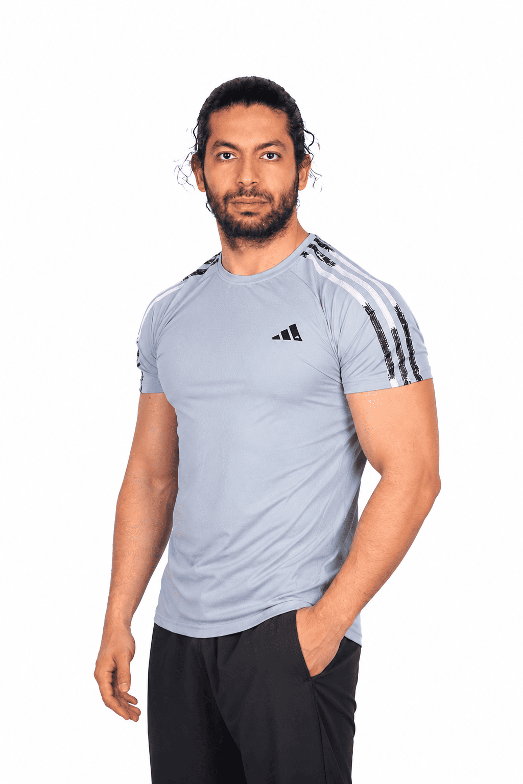 Man wearing a light blue Adidas t-shirt with three stripes on a white background