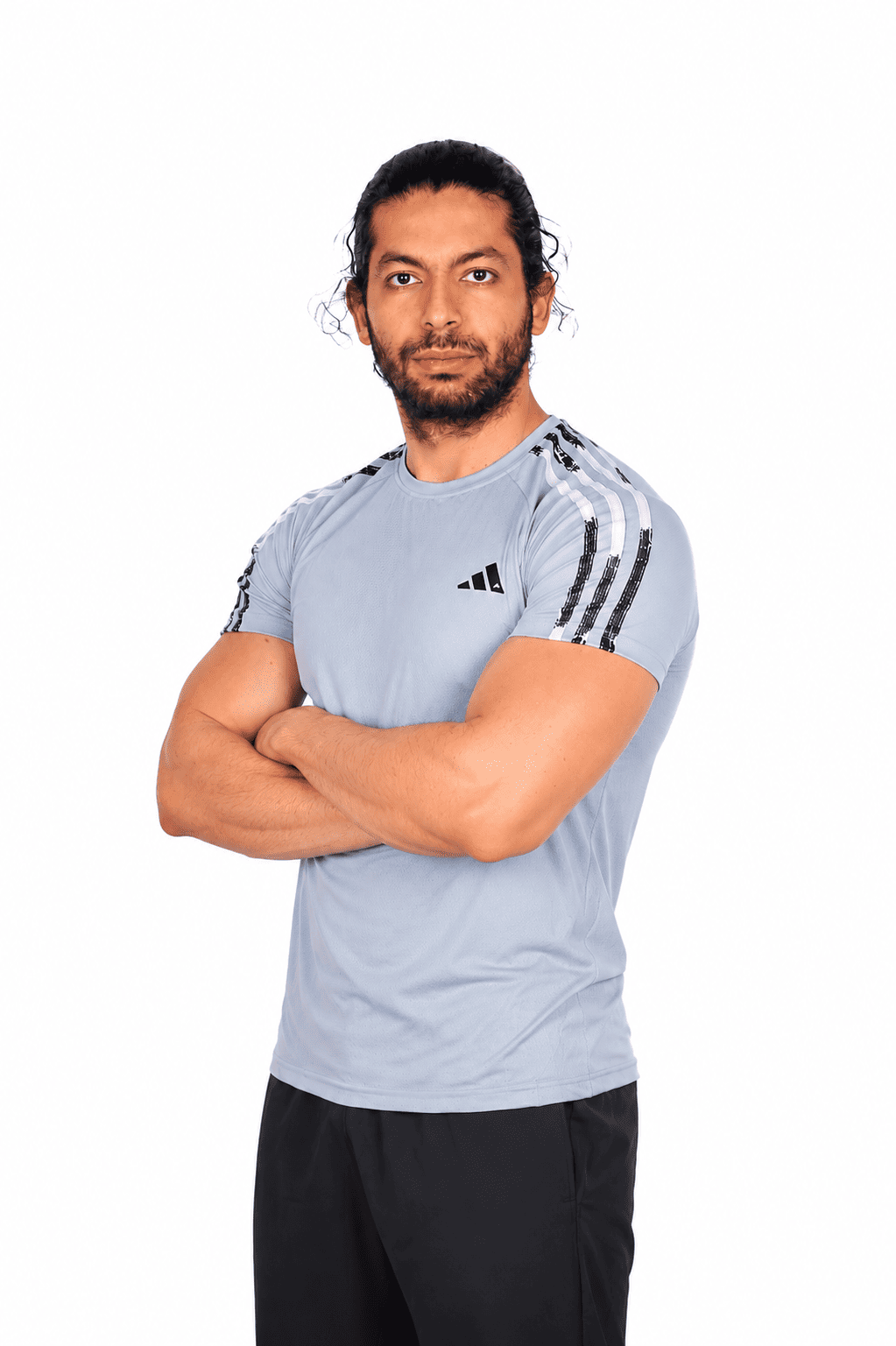 Man wearing a light blue athletic shirt with stripes on a white background