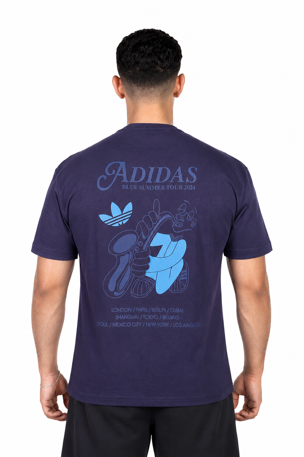 Person wearing a navy Adidas t-shirt with blue graphics on the back against a background