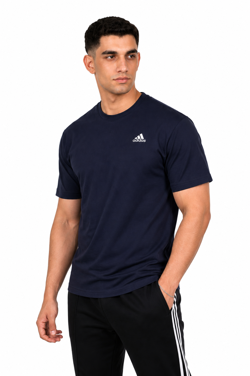 Man wearing a navy blue Adidas t-shirt and black pants with white stripes on a background