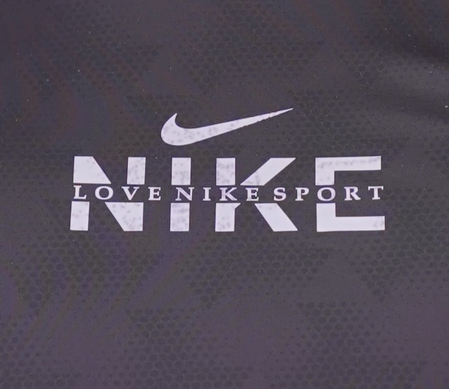 Nike black logo and text on a dark textured background