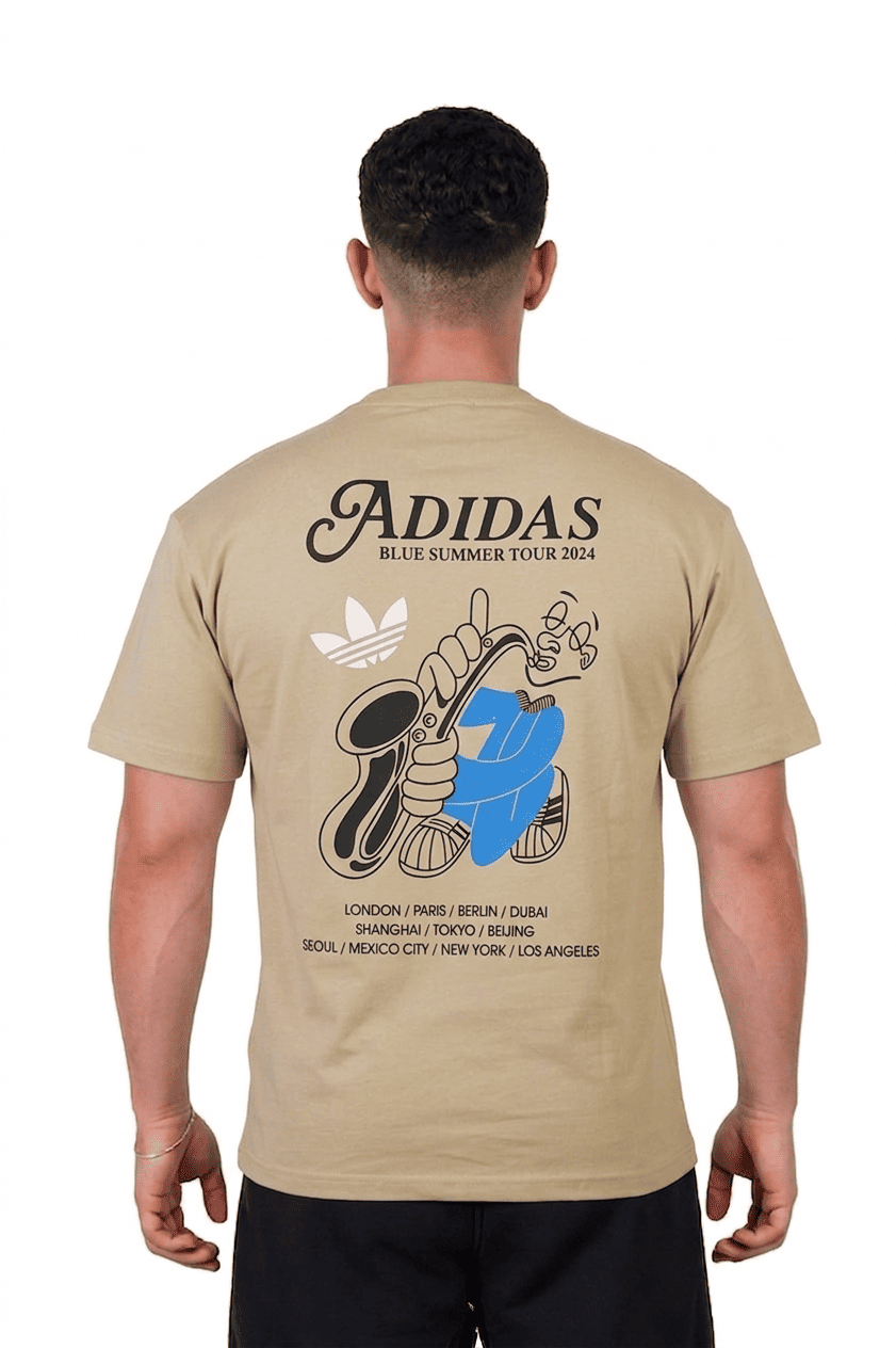 Man wearing a beige Adidas t-shirt with graphic design on the back