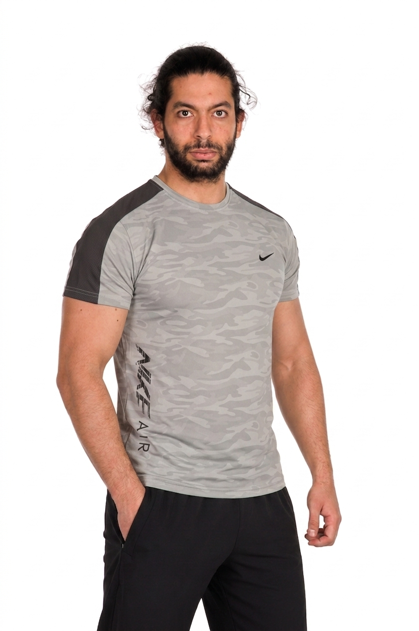 Man wearing a gray Nike athletic shirt with sleeves on a background