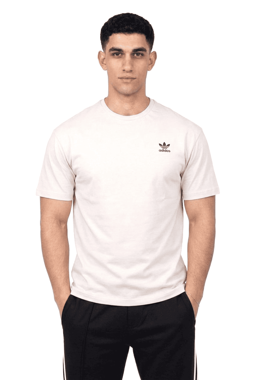 Person wearing a white Adidas t-shirt on a white background