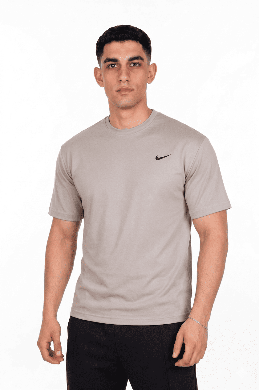Man wearing a beige Nike t-shirt on a background
