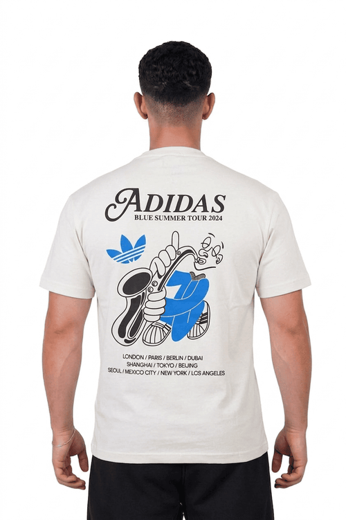 Person wearing a white Adidas t-shirt with a graphic design on the back
