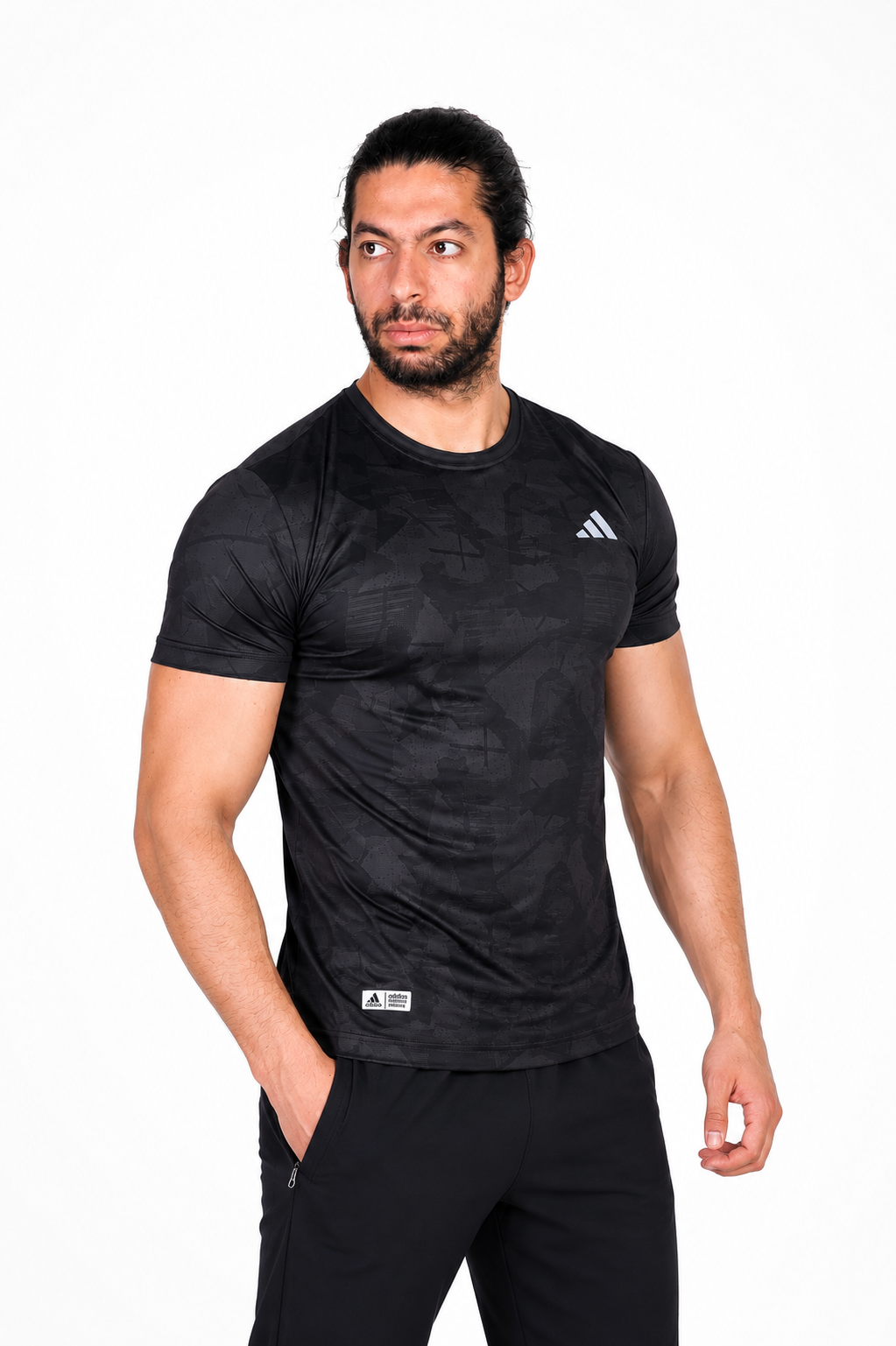 Man wearing a black Adidas t-shirt on a background