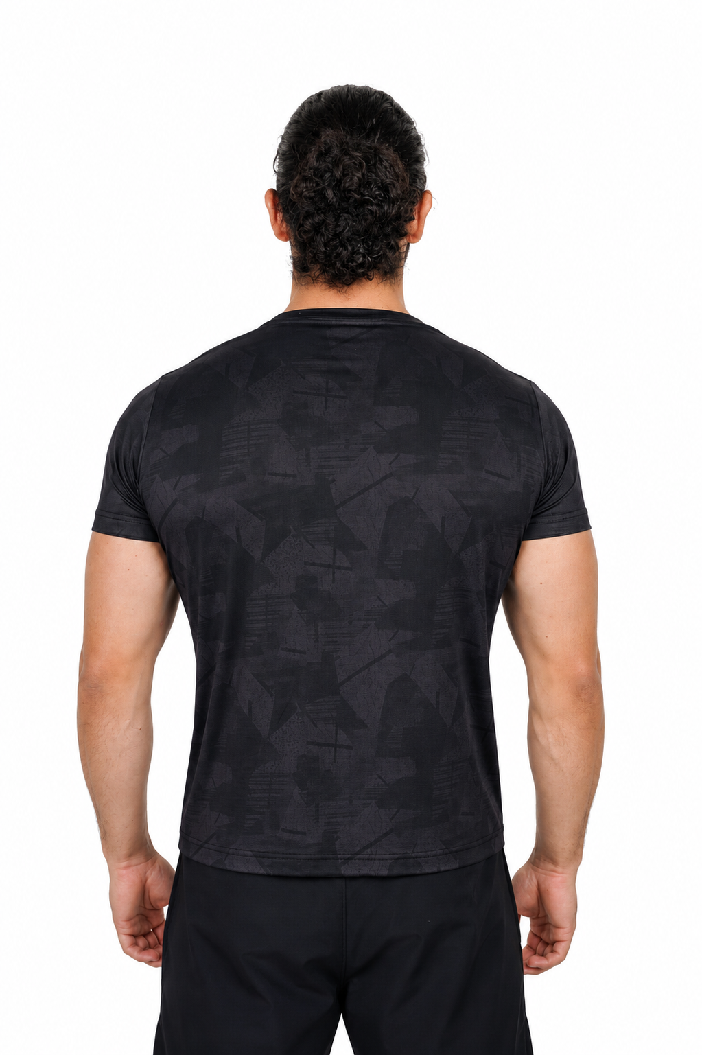 Person wearing a black patterned t-shirt on a background