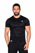 Man wearing a black Adidas t-shirt on a background