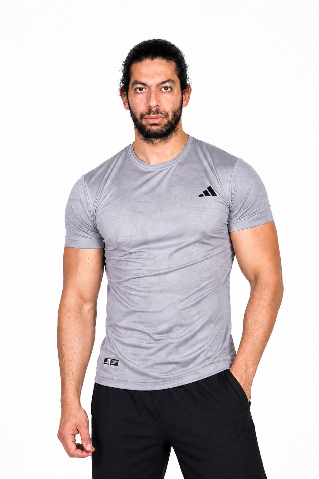Man wearing a gray Adidas t-shirt on a background