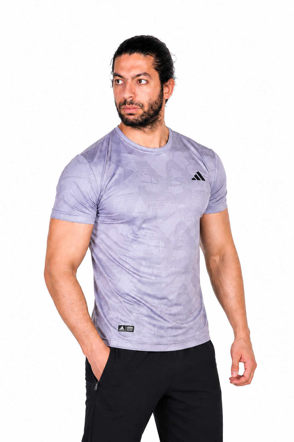 Man wearing a gray Adidas t-shirt on a background