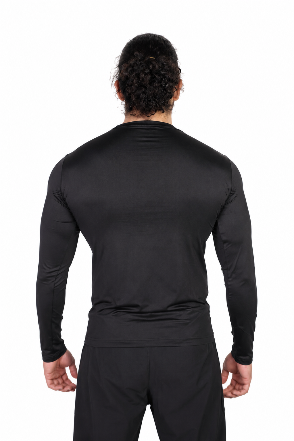 Person wearing a black long-sleeve athletic shirt and pants on a background