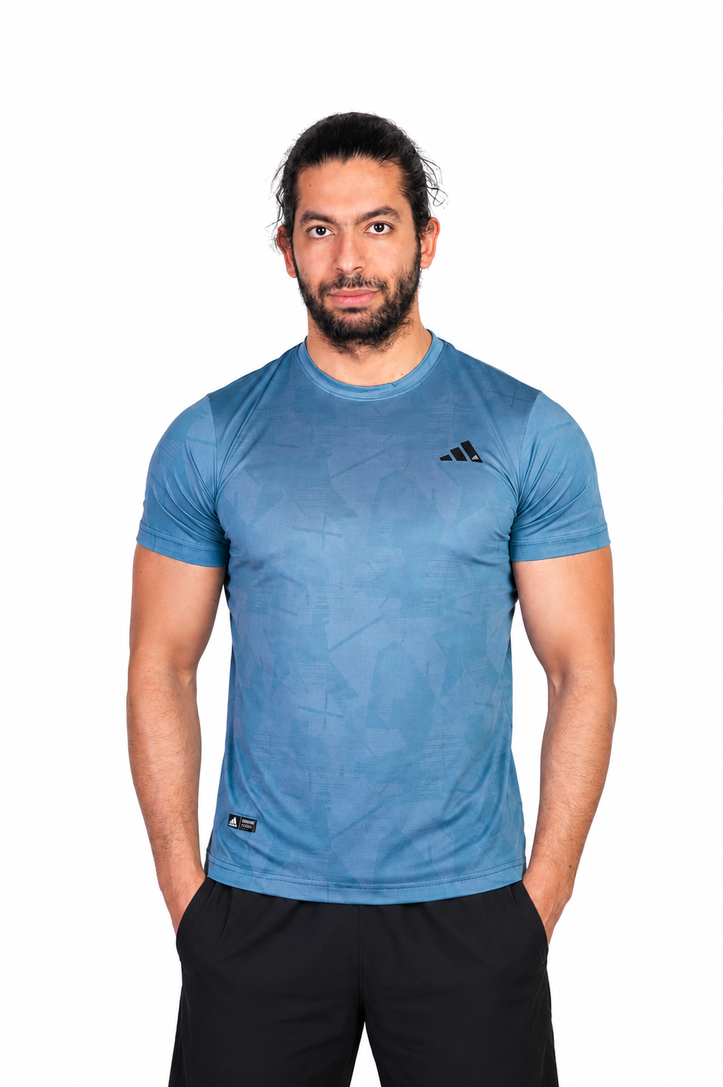 Man wearing a turquaz Adidas t-shirt on a background