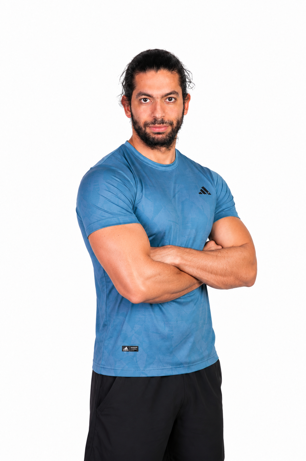 Man wearing a turquaz Adidas t-shirt on a background